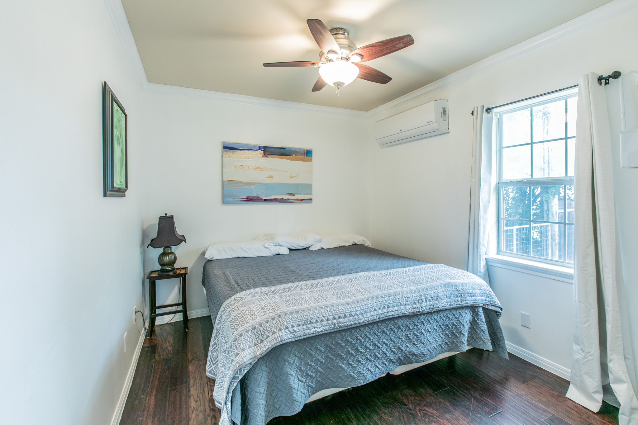 1107 Vargas Road Austin, TX 78741 - Photo 11 of 17 Well-lit sleeping quarters with rich hardwood flooring and a refreshing ceiling fan.