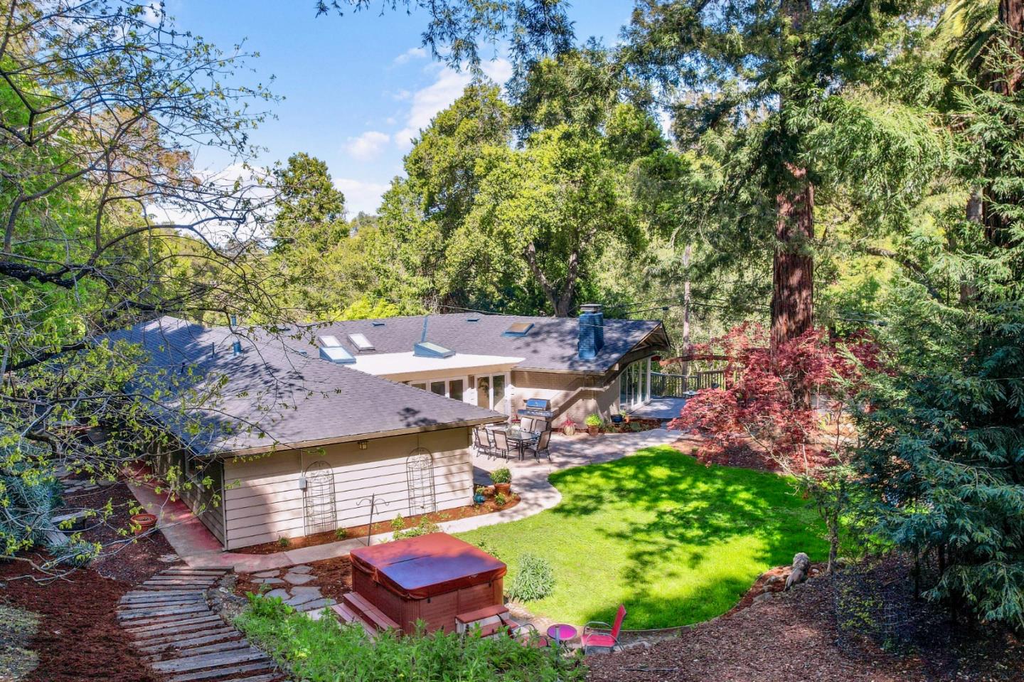 22303 Regnart Road Cupertino, CA 95014 - Photo 4 of 23 a view of a house with a garden