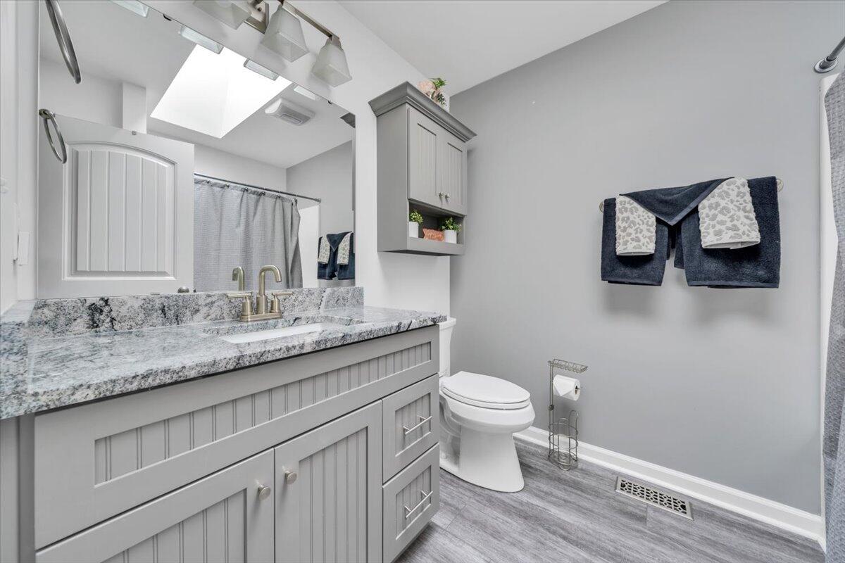 4018 Hazelridge Road Northwest Roanoke, VA 24012 - Photo 12 of 59 a bathroom with a granite countertop toilet sink and mirror