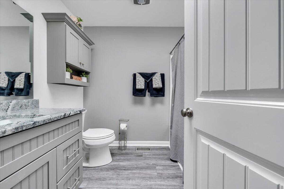 4018 Hazelridge Road Northwest Roanoke, VA 24012 - Photo 13 of 59 a bathroom with a granite countertop toilet sink and mirror