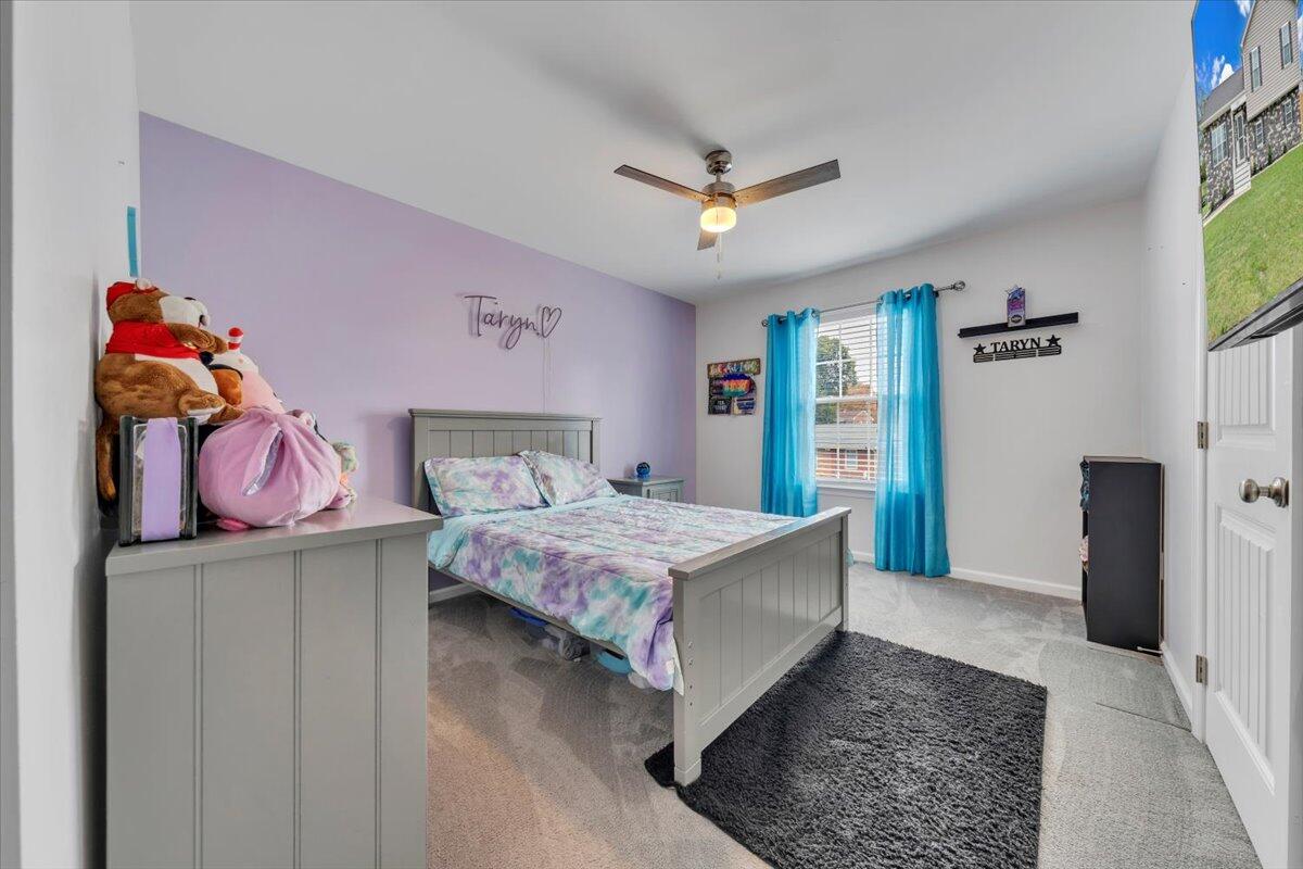 4018 Hazelridge Road Northwest Roanoke, VA 24012 - Photo 16 of 59 a bedroom with a bed and a chandelier