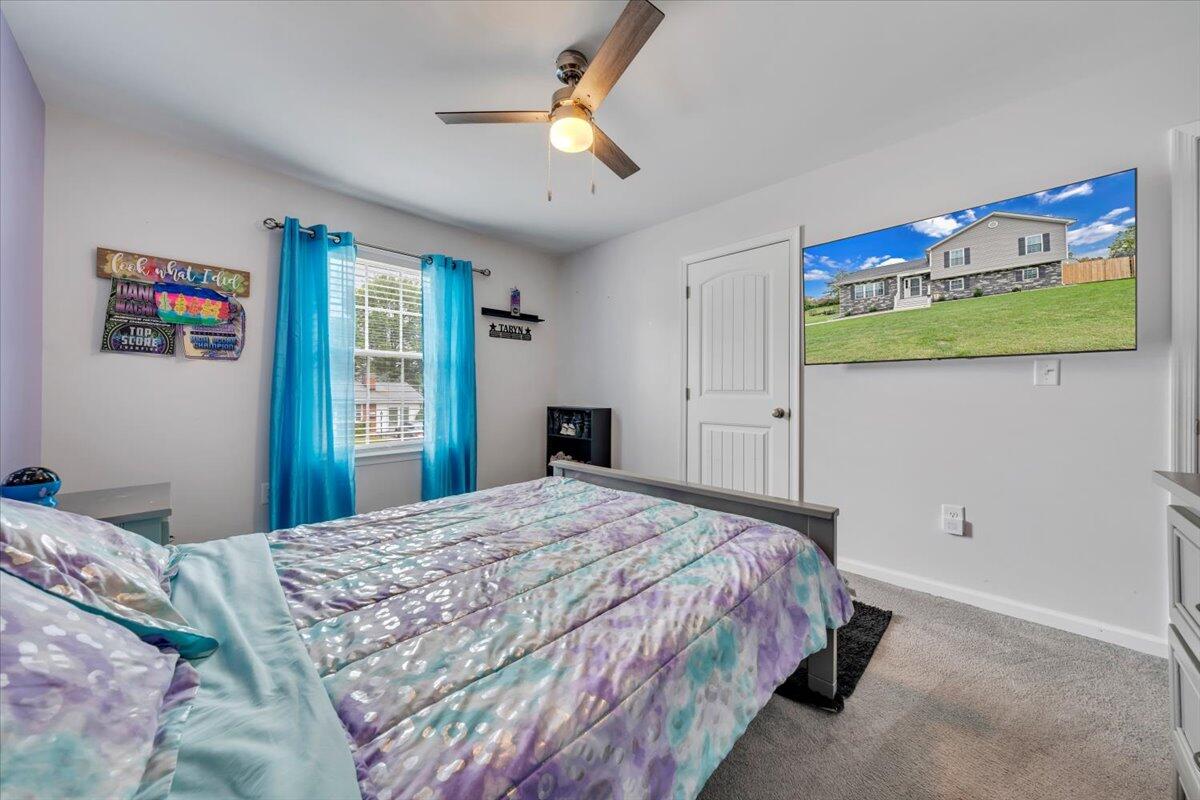 4018 Hazelridge Road Northwest Roanoke, VA 24012 - Photo 17 of 59 a bedroom with a bed and a chandelier
