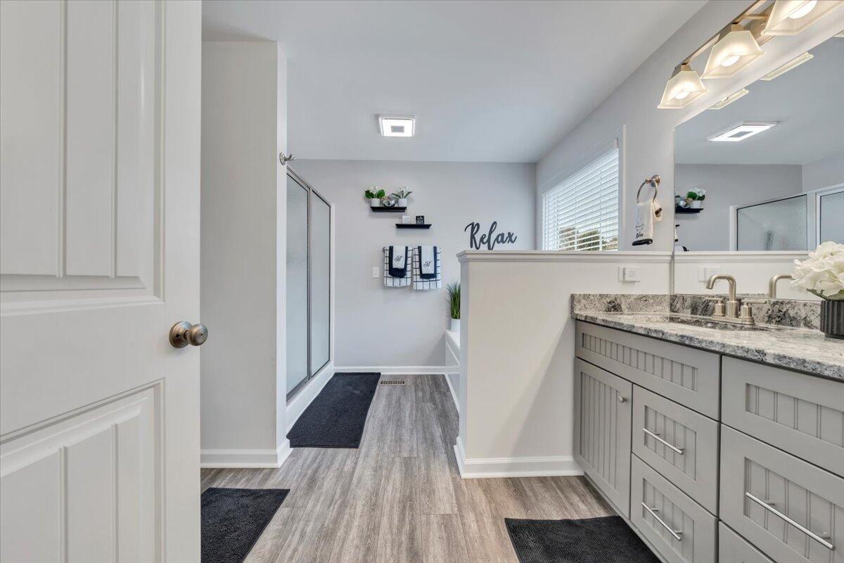 4018 Hazelridge Road Northwest Roanoke, VA 24012 - Photo 21 of 59 a kitchen with granite countertop a refrigerator a sink dishwasher and white cabinets with wooden floor