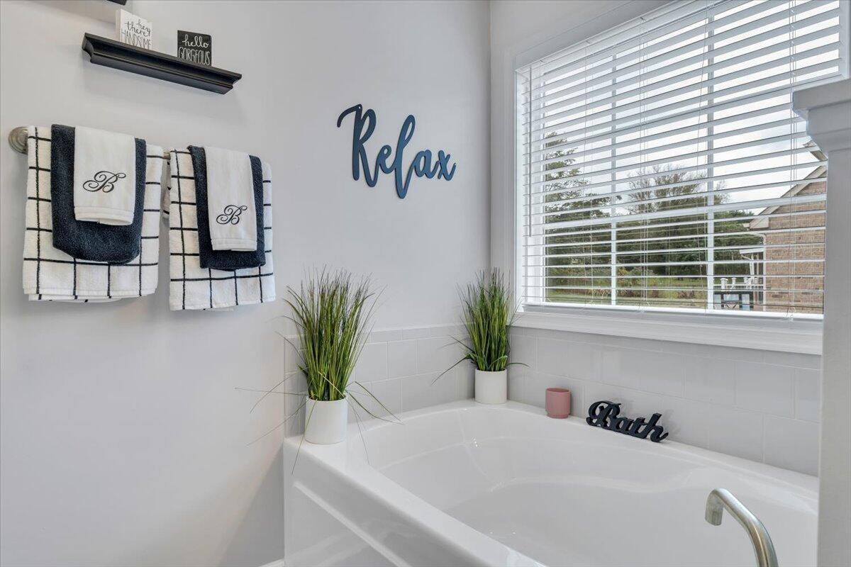 4018 Hazelridge Road Northwest Roanoke, VA 24012 - Photo 22 of 59 a white bath tub sitting in a bathroom next to a window