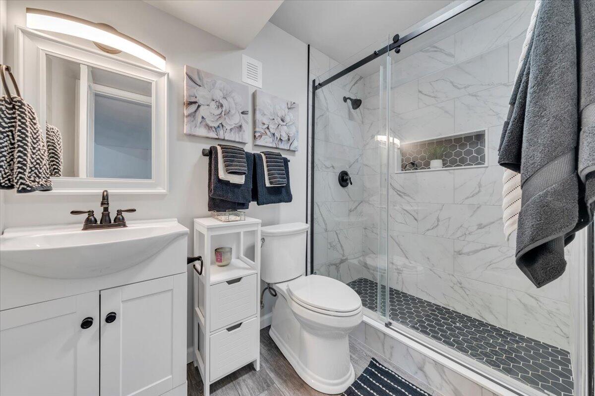 4018 Hazelridge Road Northwest Roanoke, VA 24012 - Photo 28 of 59 a bathroom with a sink toilet a mirror and shower