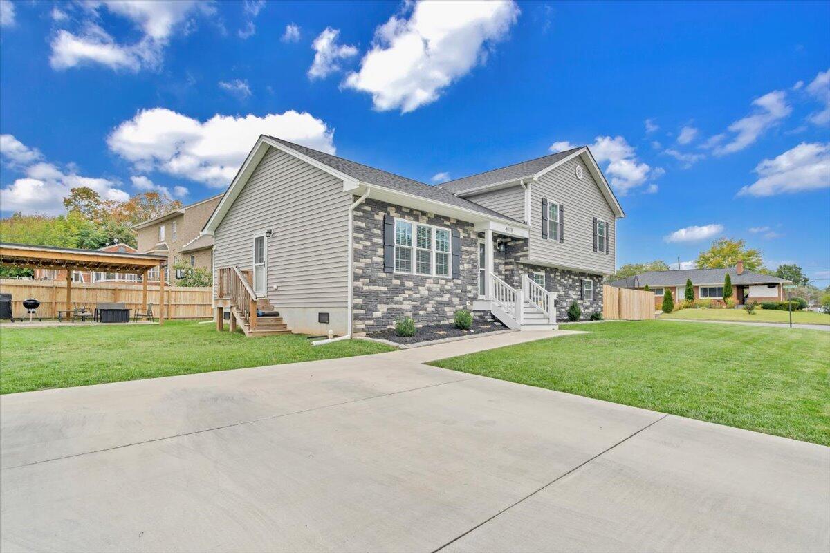 4018 Hazelridge Road Northwest Roanoke, VA 24012 - Photo 44 of 59 a view of a yard in front of a house with a large tree