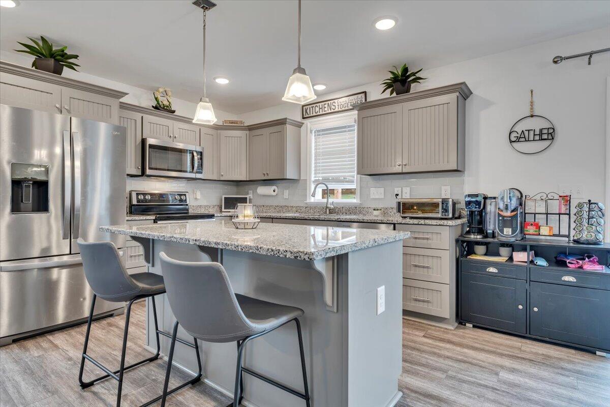 4018 Hazelridge Road Northwest Roanoke, VA 24012 - Photo 5 of 59 a kitchen with kitchen island granite countertop a sink cabinets a refrigerator and a stove
