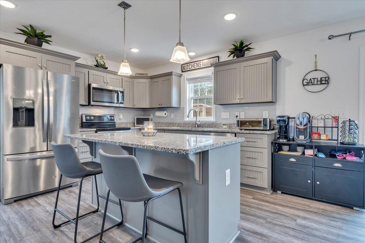 4018 Hazelridge Road Northwest Roanoke, VA 24012 - Photo 6 of 59 a kitchen with kitchen island granite countertop a sink a counter space appliances and cabinets