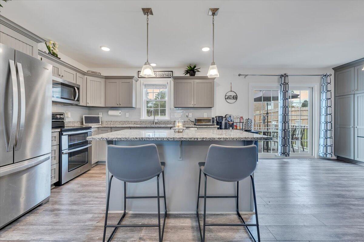 4018 Hazelridge Road Northwest Roanoke, VA 24012 - Photo 7 of 59 a kitchen with stainless steel appliances granite countertop a sink a stove a refrigerator and wooden floor