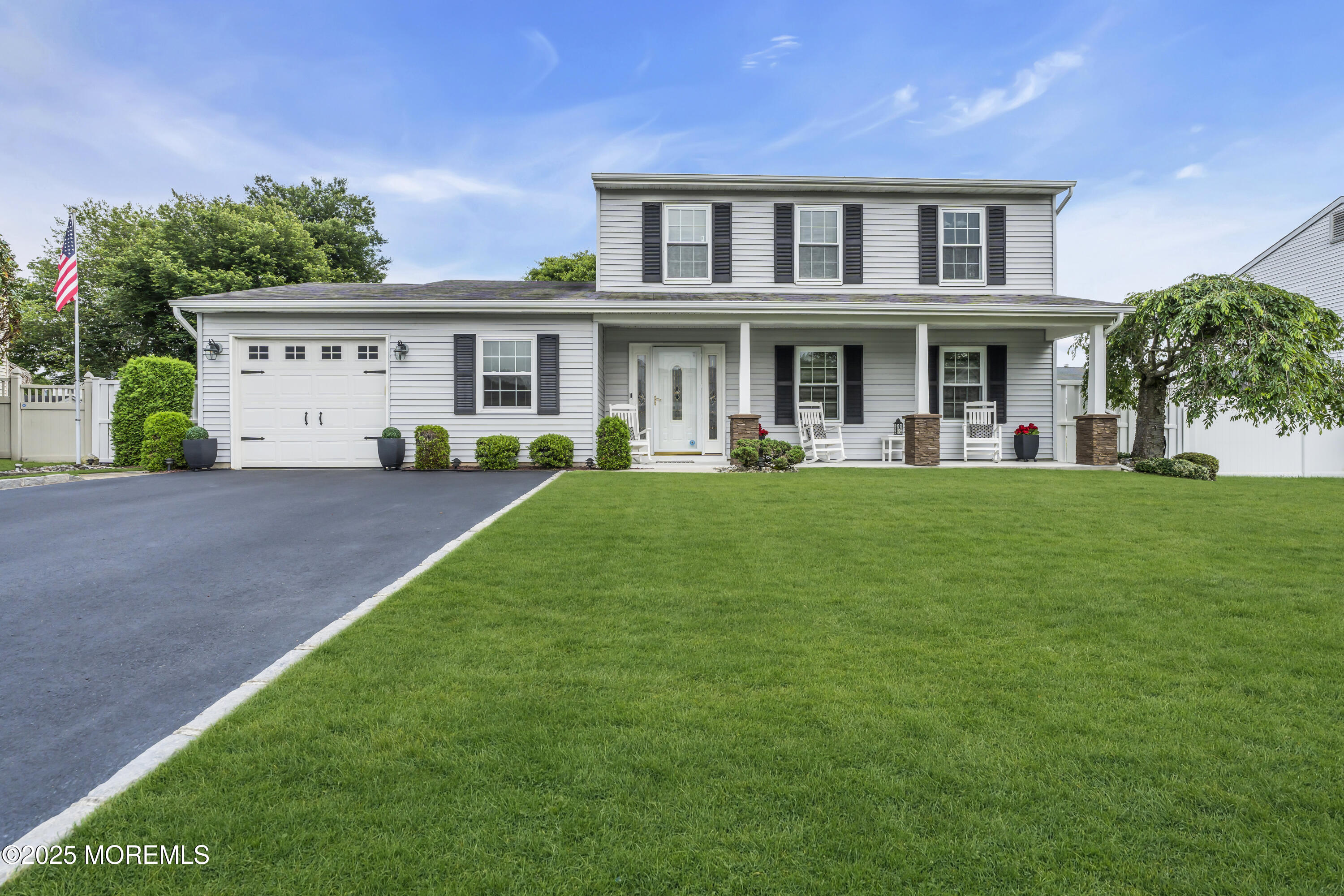32 Kiwi Loop Howell, NJ 07731 - Photo 1 of 42 a view of a white house with a big yard and potted plants