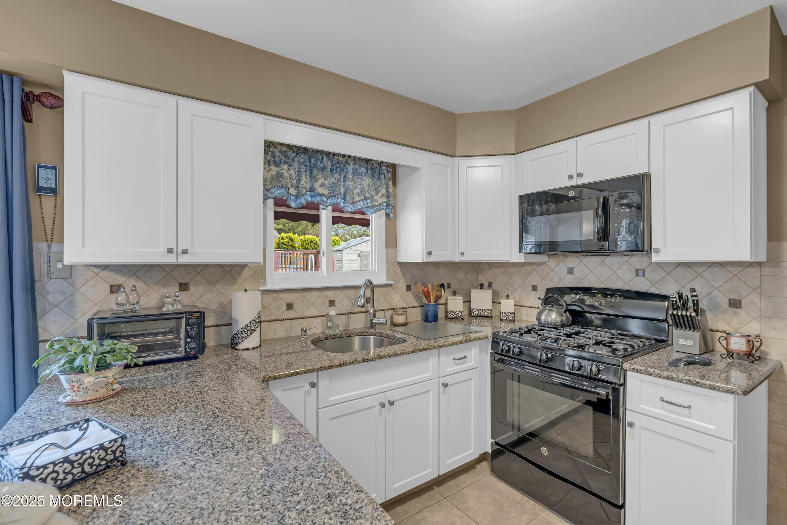 32 Kiwi Loop Howell, NJ 07731 - Photo 11 of 42 a kitchen with stainless steel appliances granite countertop a stove a sink and a white cabinets