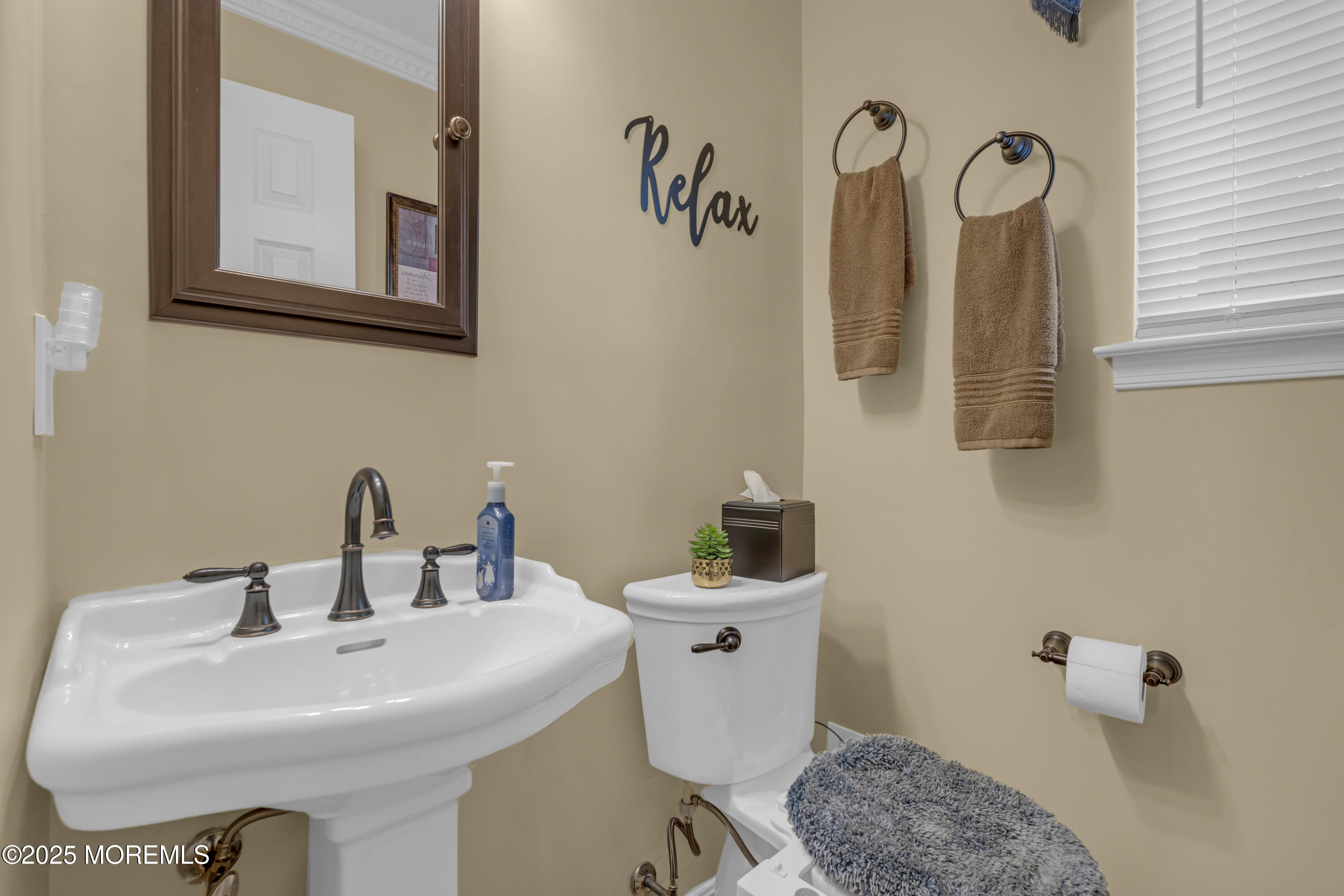 32 Kiwi Loop Howell, NJ 07731 - Photo 15 of 42 a bathroom with a toilet sink and mirror