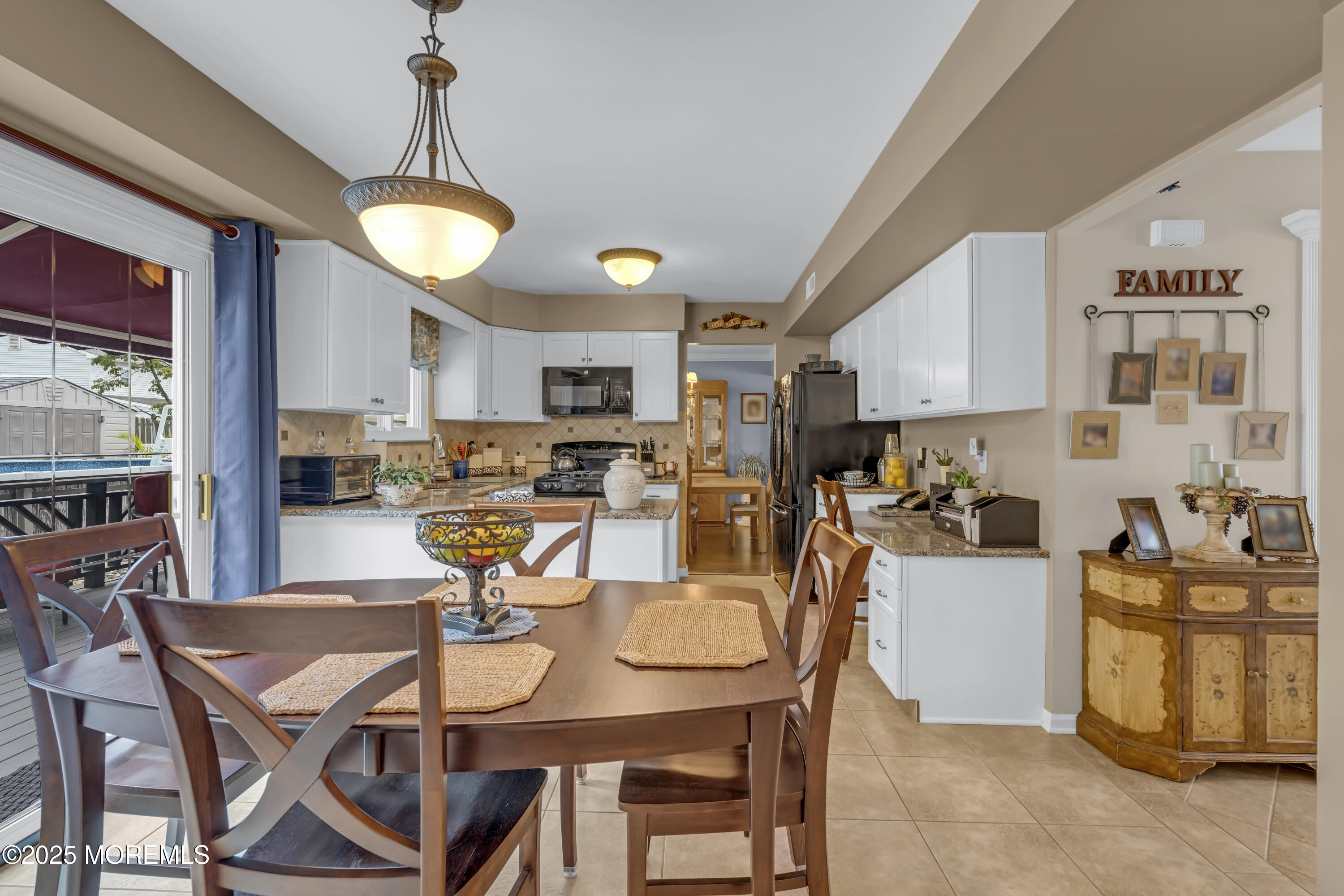 32 Kiwi Loop Howell, NJ 07731 - Photo 16 of 42 a view of a dining room with furniture and a chandelier