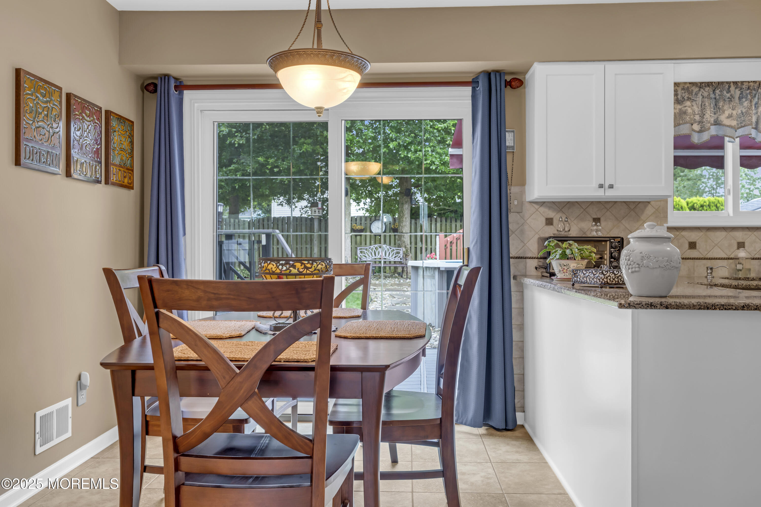32 Kiwi Loop Howell, NJ 07731 - Photo 18 of 42 a dining room with furniture a chandelier and wooden floor