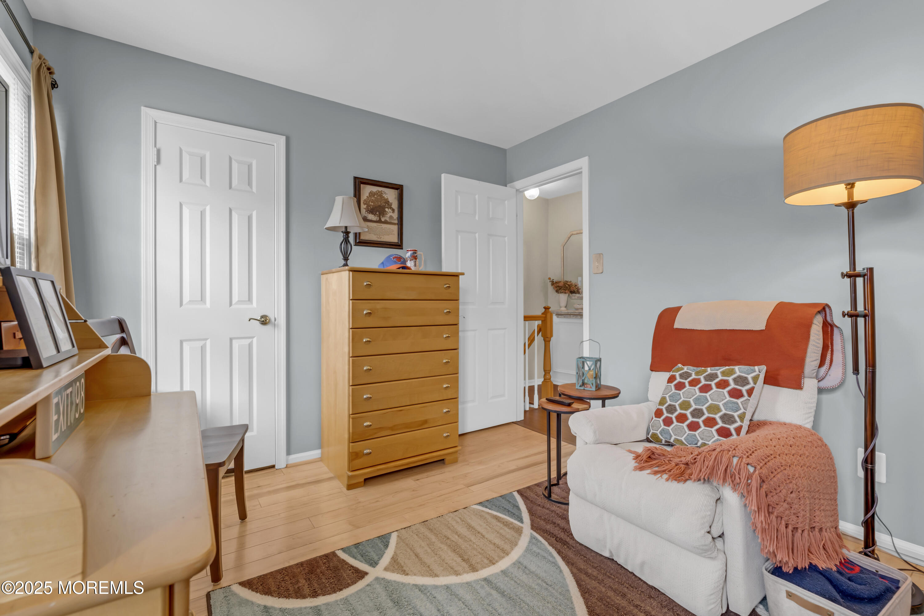 32 Kiwi Loop Howell, NJ 07731 - Photo 20 of 42 a bedroom with a bed and a chair