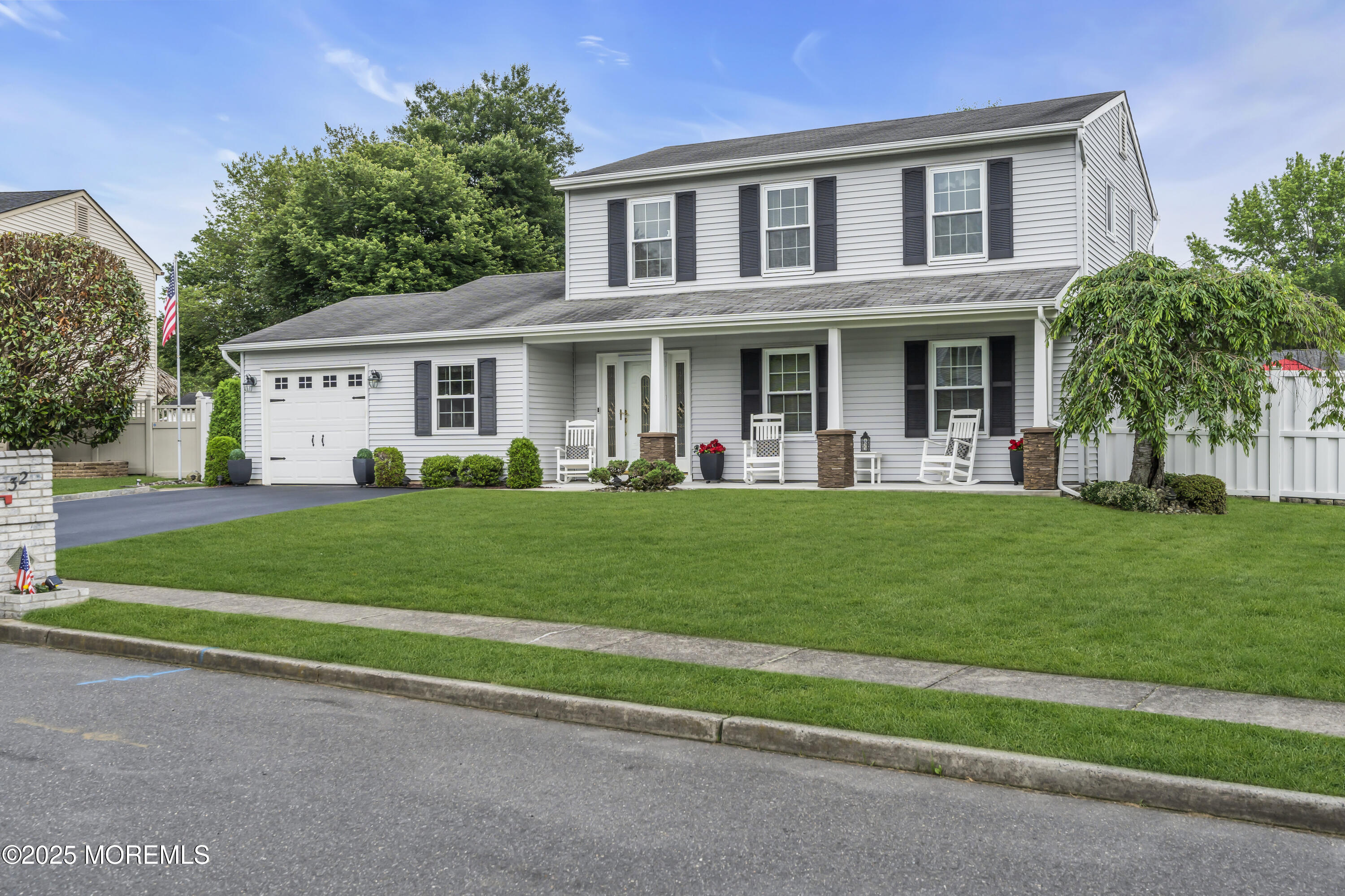 32 Kiwi Loop Howell, NJ 07731 - Photo 2 of 42 a front view of a house with a garden and yard