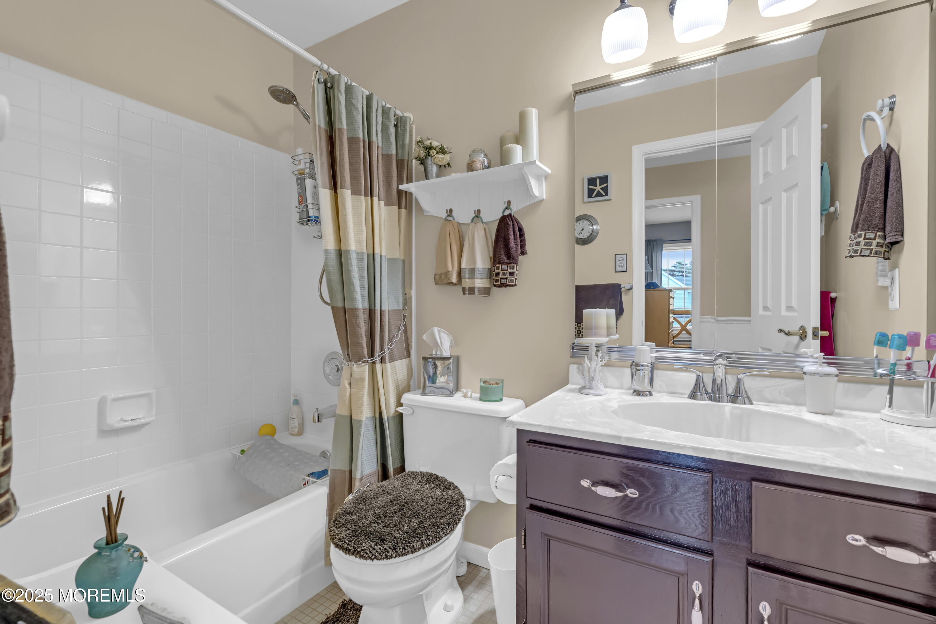 32 Kiwi Loop Howell, NJ 07731 - Photo 21 of 42 a bathroom with a sink a toilet and a mirror