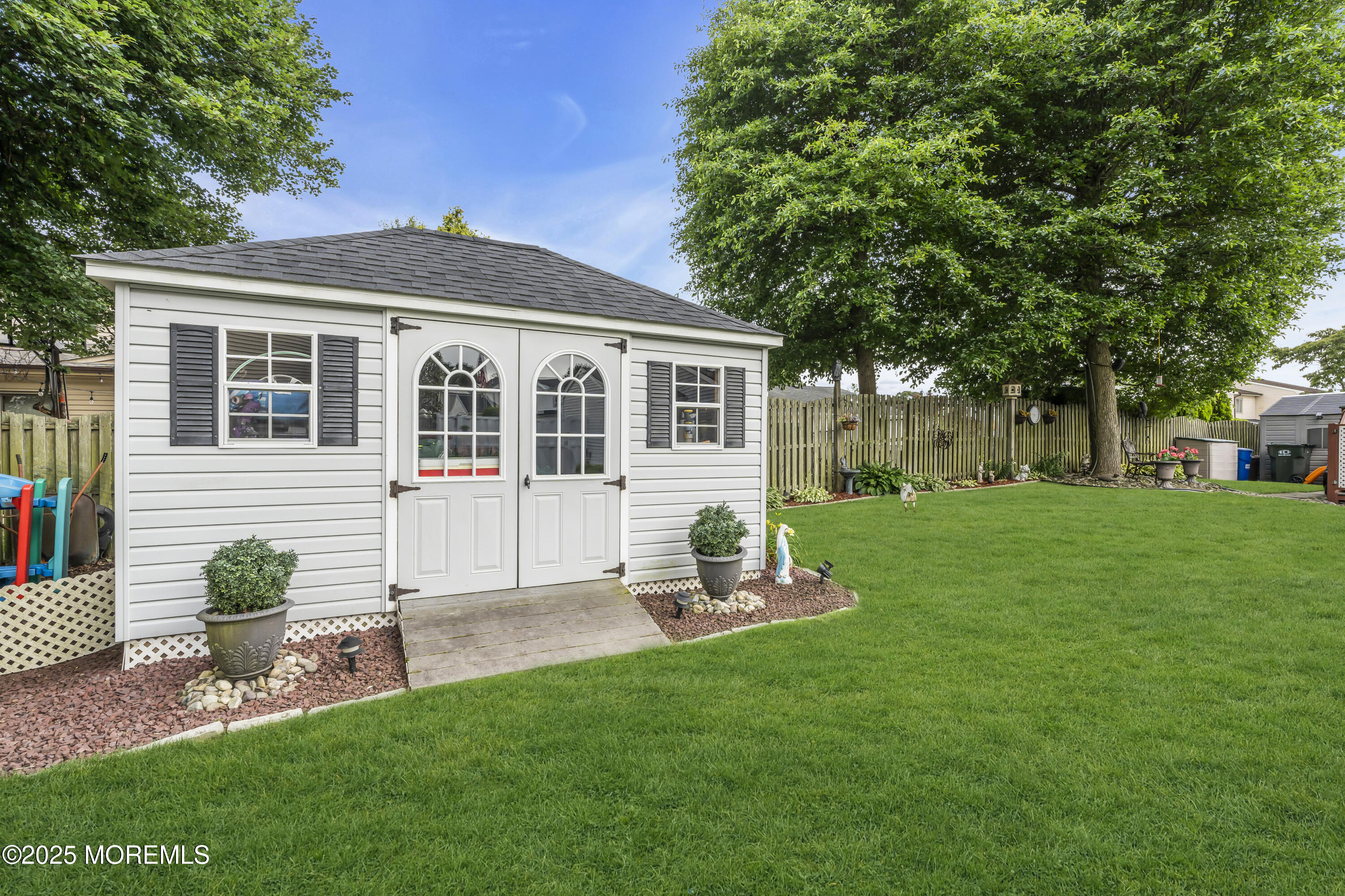 32 Kiwi Loop Howell, NJ 07731 - Photo 31 of 42 a front view of a house with a garden and trees