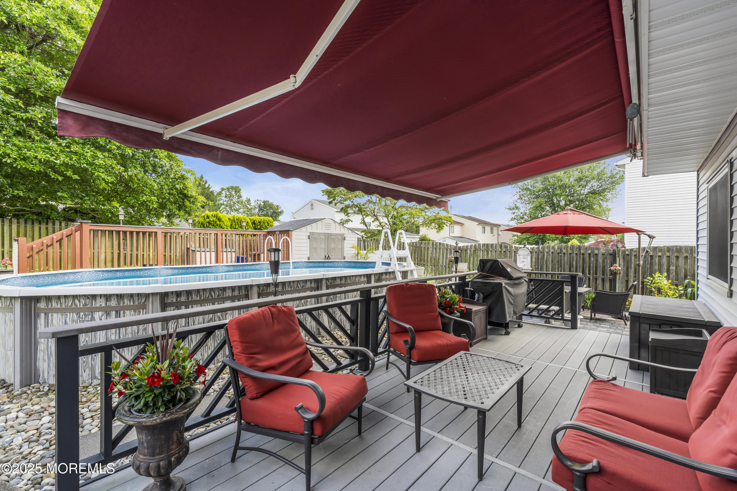 32 Kiwi Loop Howell, NJ 07731 - Photo 33 of 42 an outdoor sitting area with furniture and umbrella