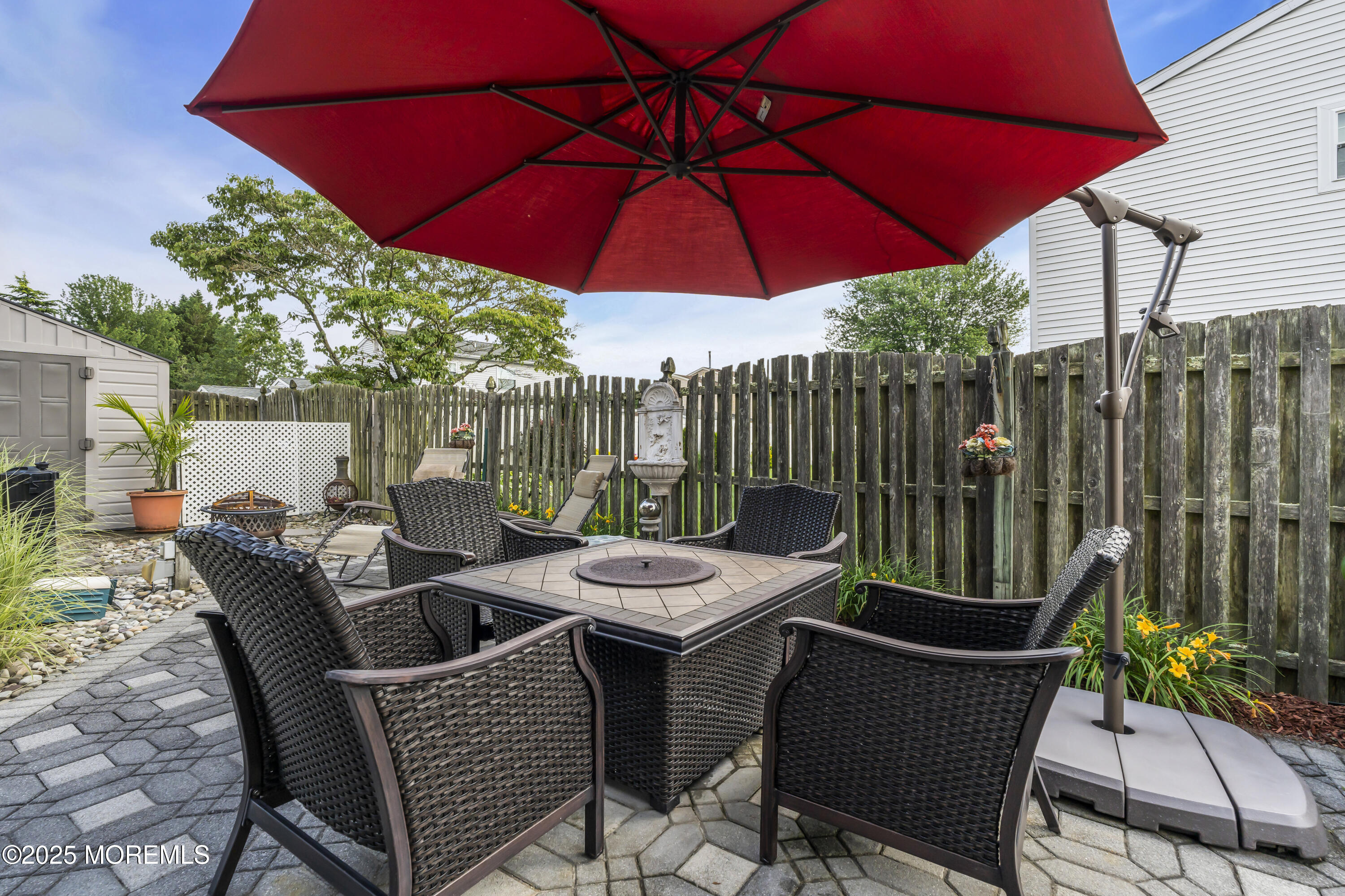 32 Kiwi Loop Howell, NJ 07731 - Photo 36 of 42 a view of a patio with furniture and umbrella