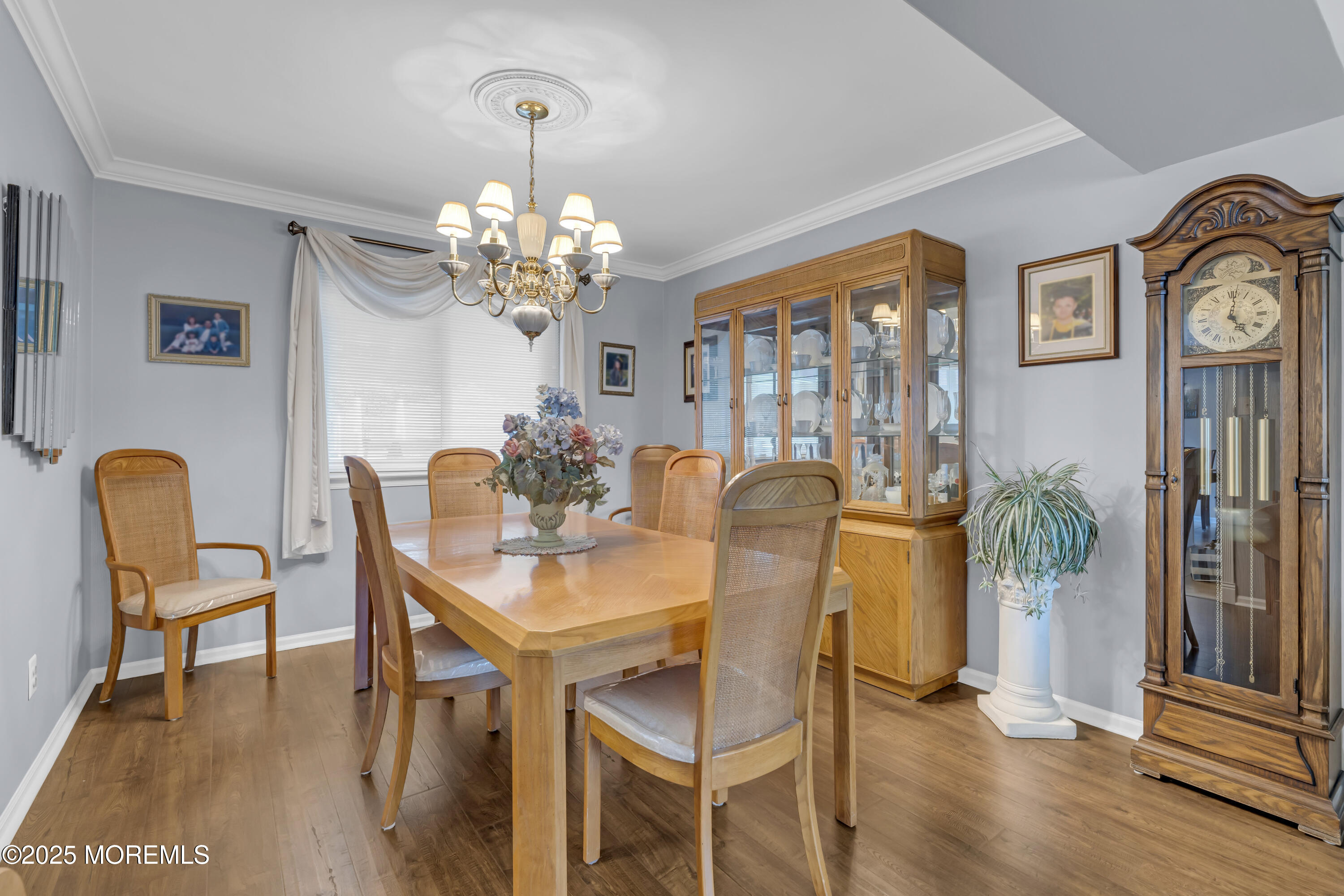 32 Kiwi Loop Howell, NJ 07731 - Photo 8 of 42 a view of a dining room with furniture a chandelier and wooden floor