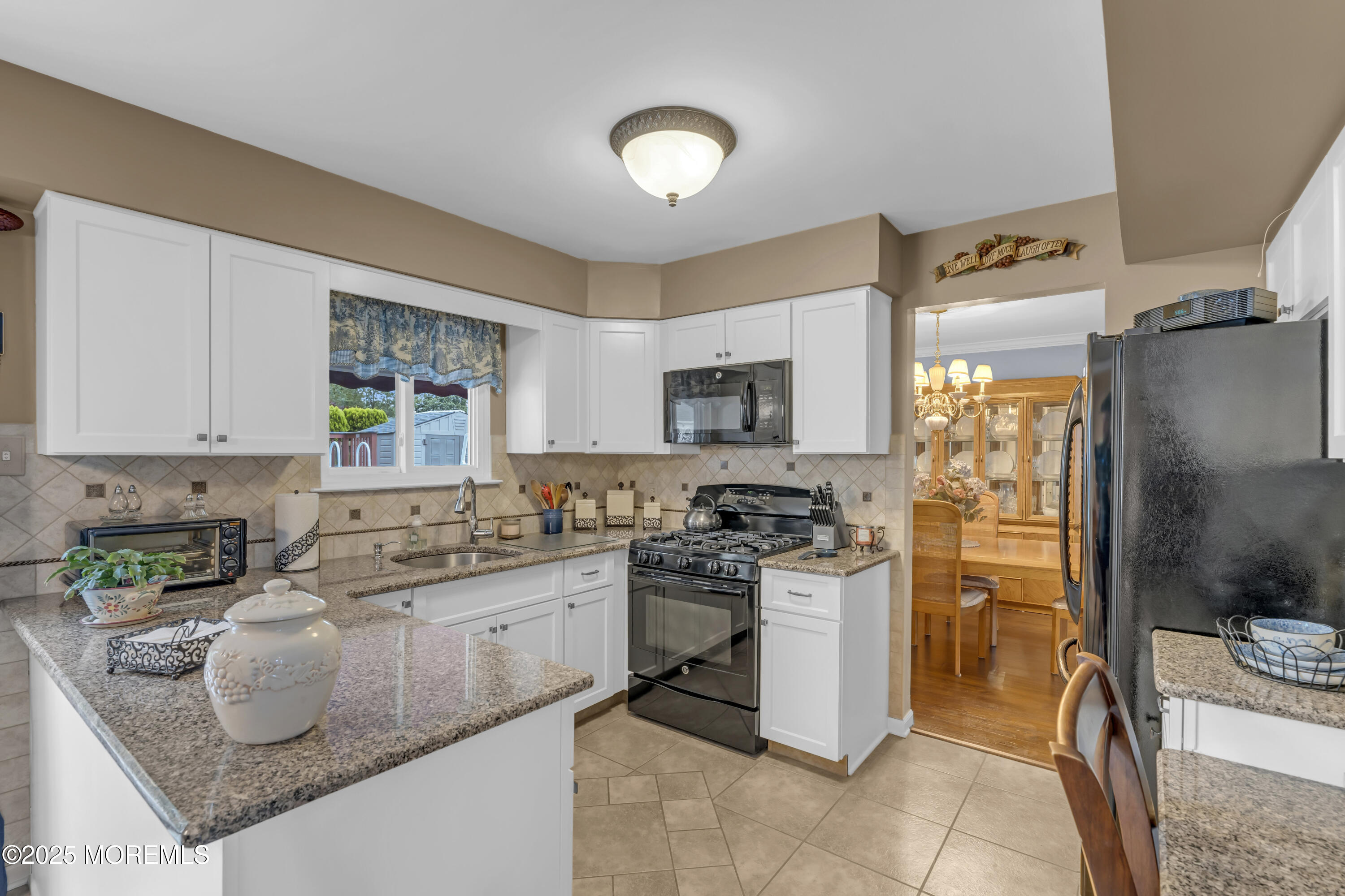 32 Kiwi Loop Howell, NJ 07731 - Photo 10 of 42 a kitchen with stainless steel appliances granite countertop a stove top oven a sink a counter space and cabinets