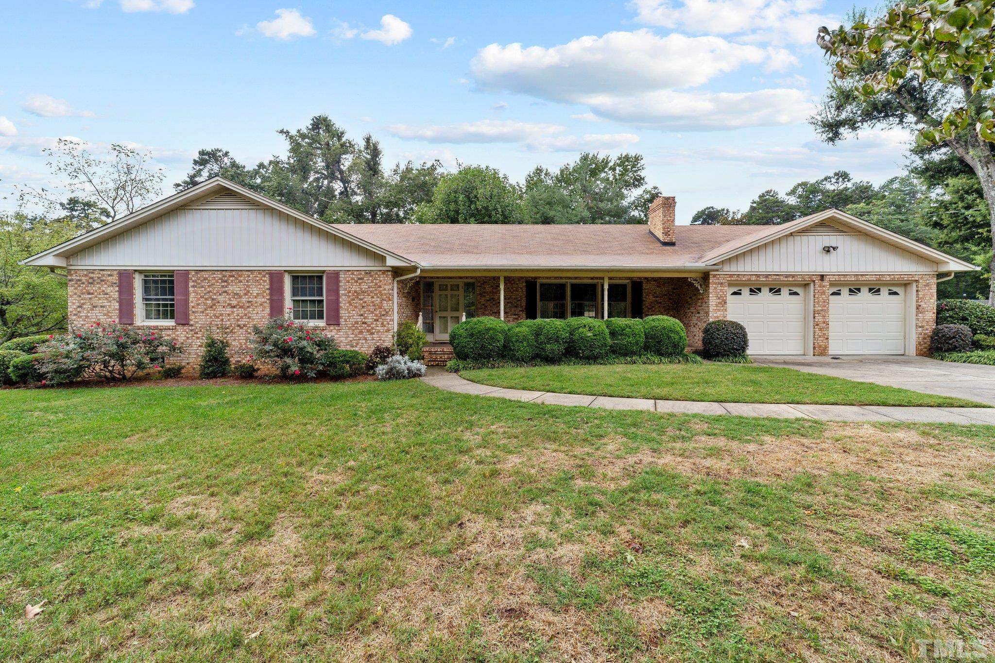 261 Badger Circle Roxboro, NC 27573 - Photo 1 of 30 a view of a house with a big yard and potted plants
