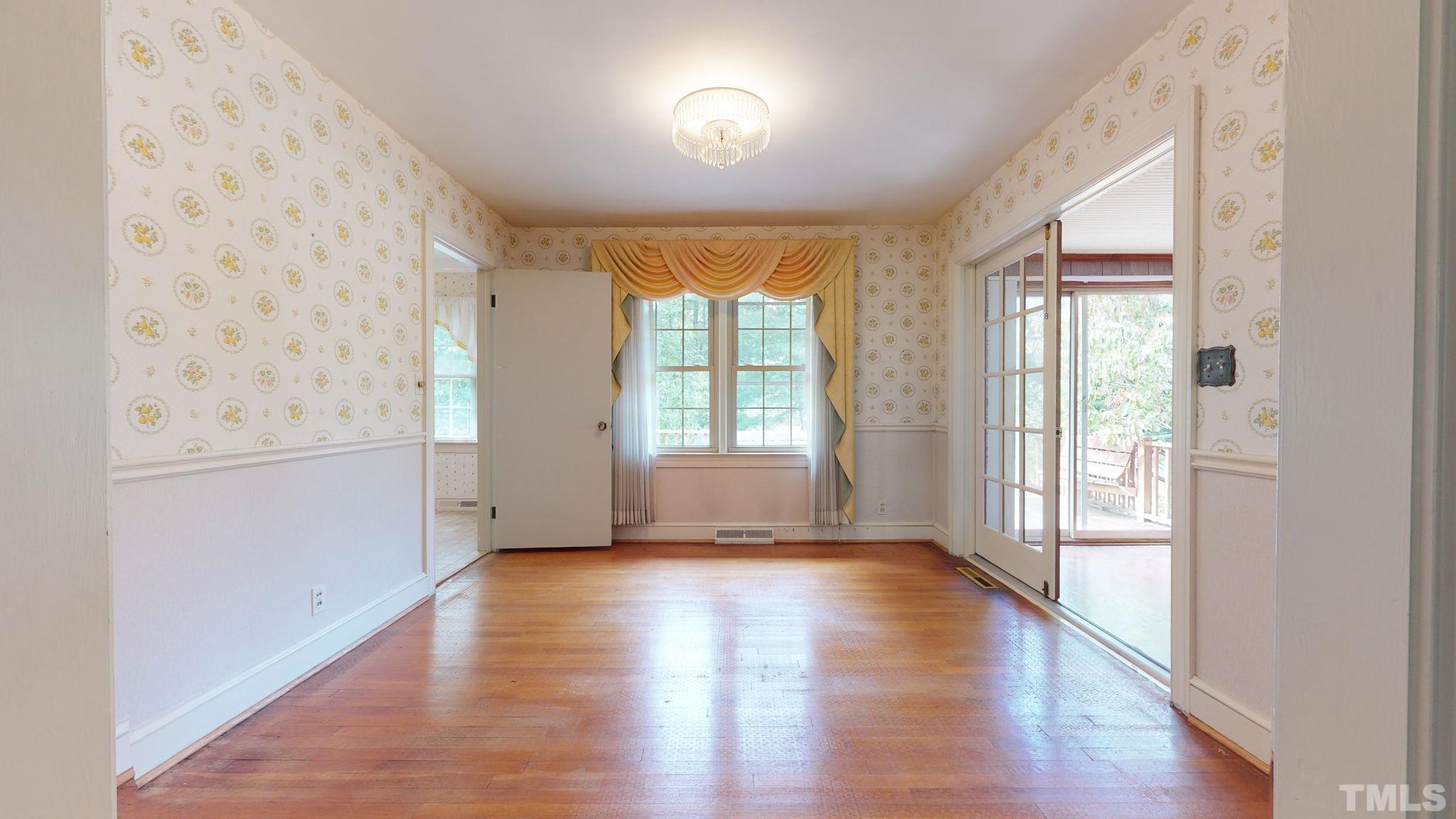 261 Badger Circle Roxboro, NC 27573 - Photo 12 of 30 a view of an empty room with wooden floor and a window