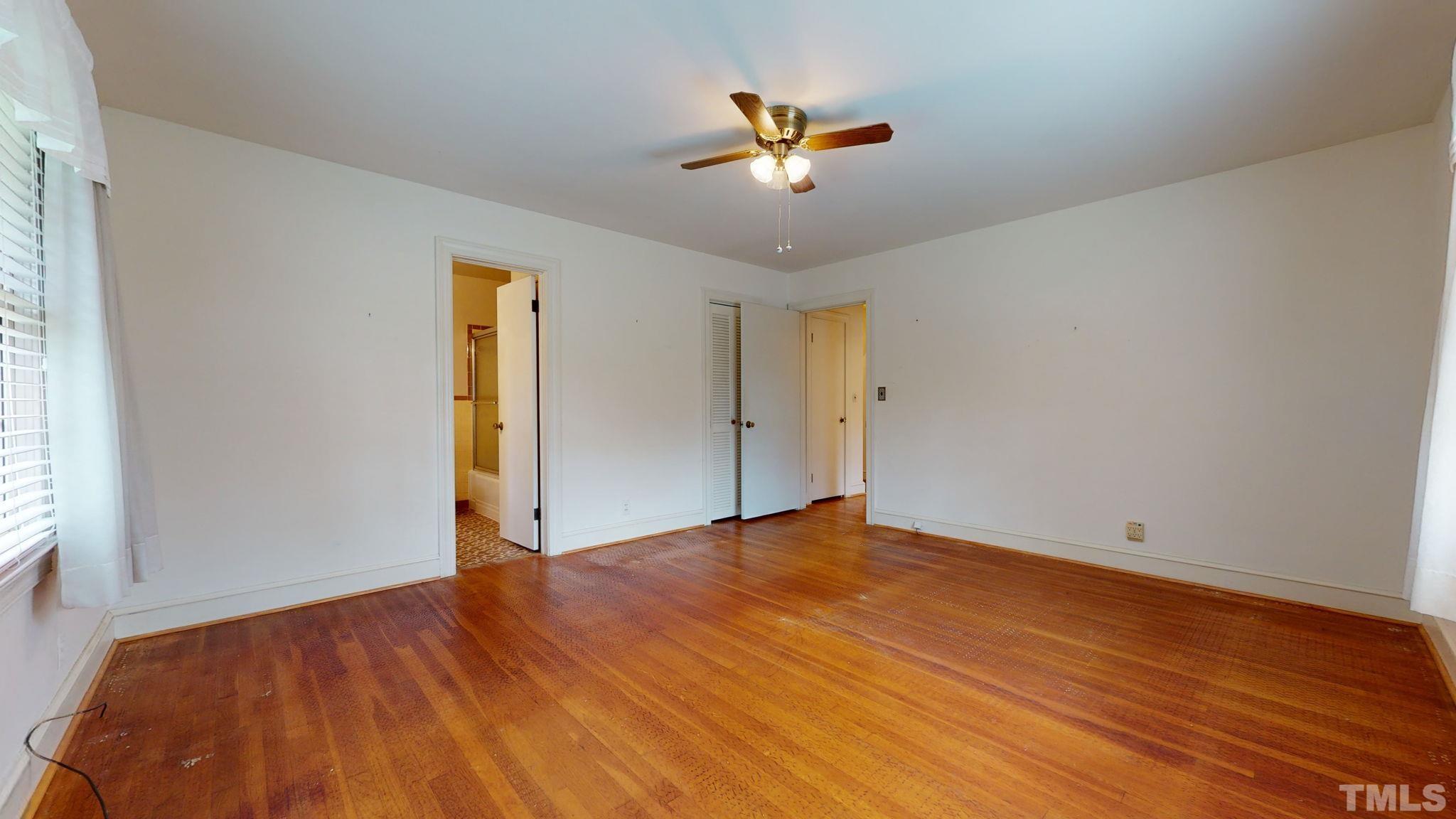261 Badger Circle Roxboro, NC 27573 - Photo 14 of 30 a view of empty room with wooden floor and fan