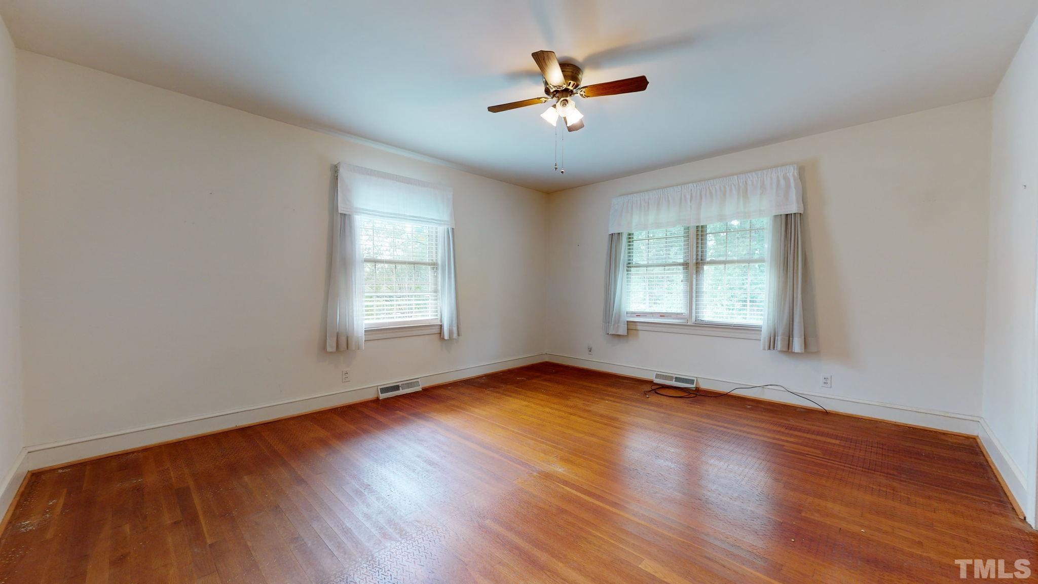 261 Badger Circle Roxboro, NC 27573 - Photo 15 of 30 a view of empty room with wooden floor and fan