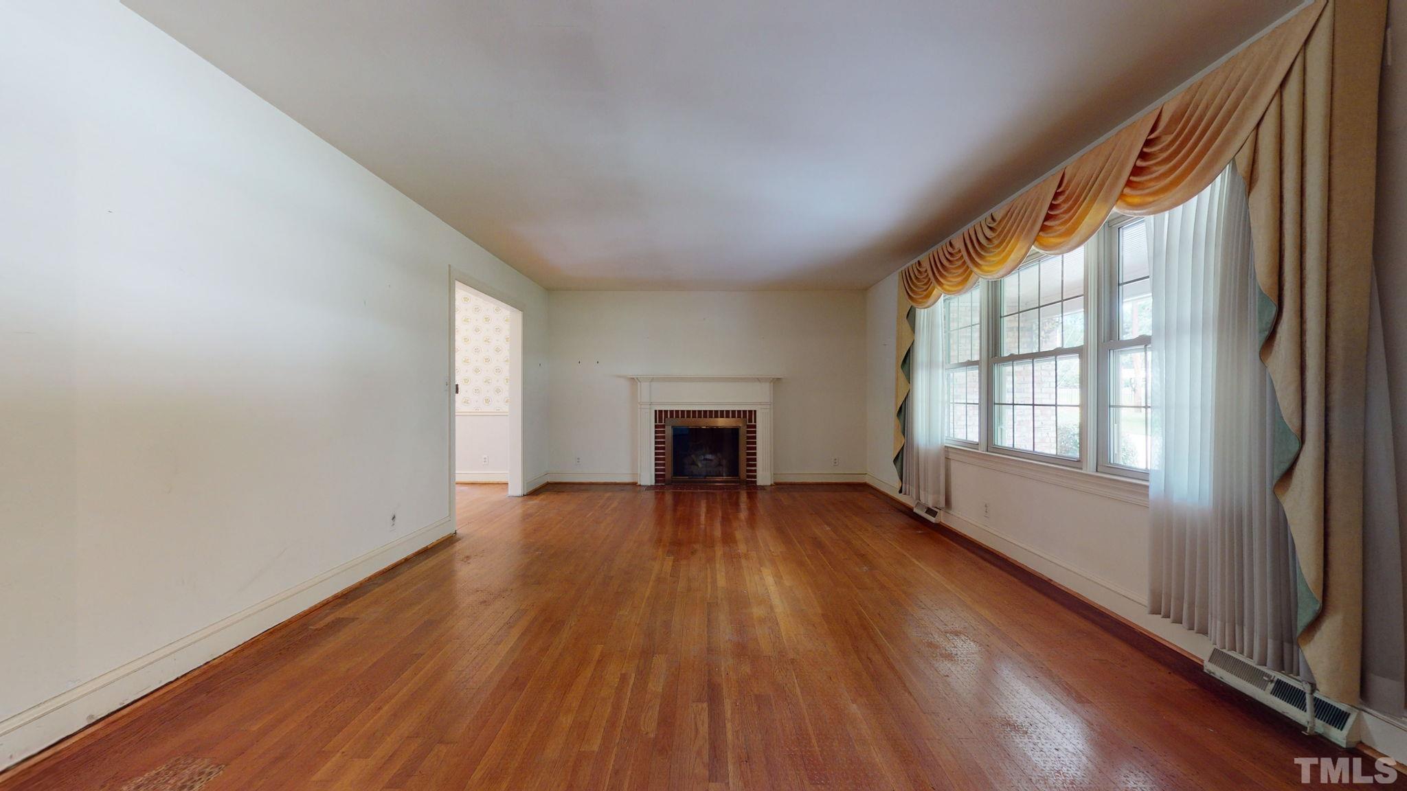 261 Badger Circle Roxboro, NC 27573 - Photo 5 of 30 a view of an empty room with wooden floor and a window