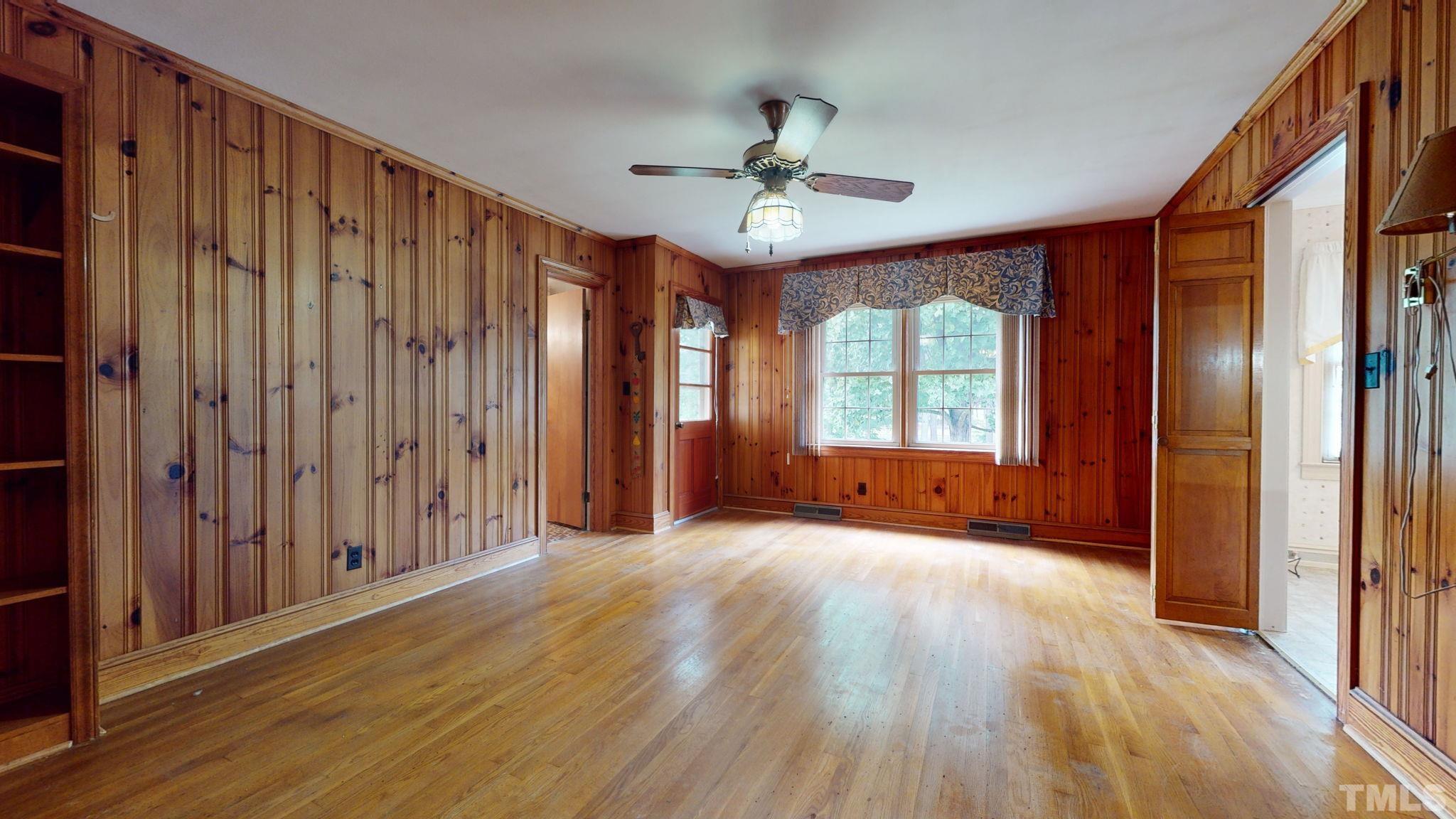 261 Badger Circle Roxboro, NC 27573 - Photo 7 of 30 a view of an empty room with wooden floor and a window