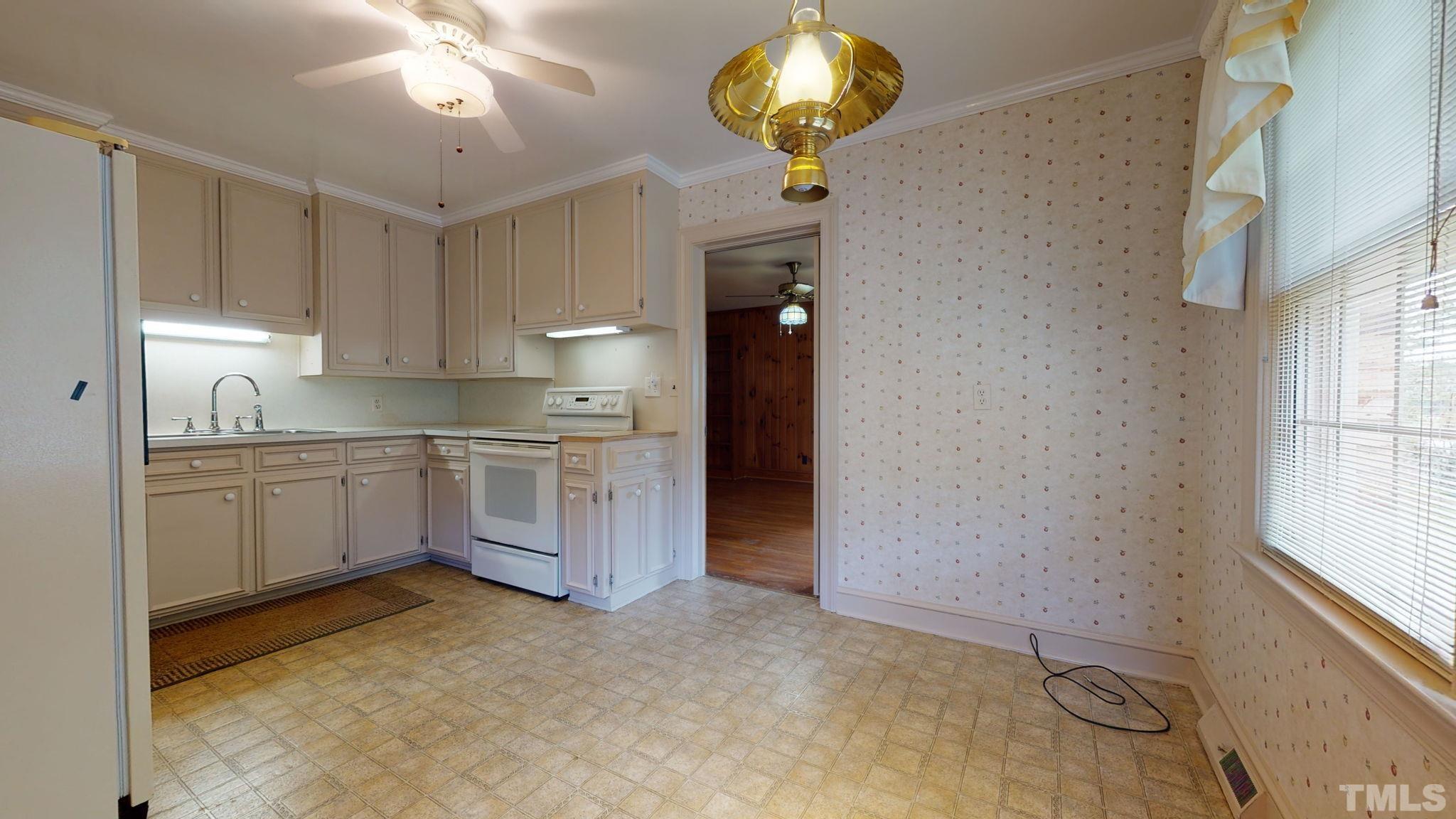 261 Badger Circle Roxboro, NC 27573 - Photo 10 of 30 a kitchen with a refrigerator and window