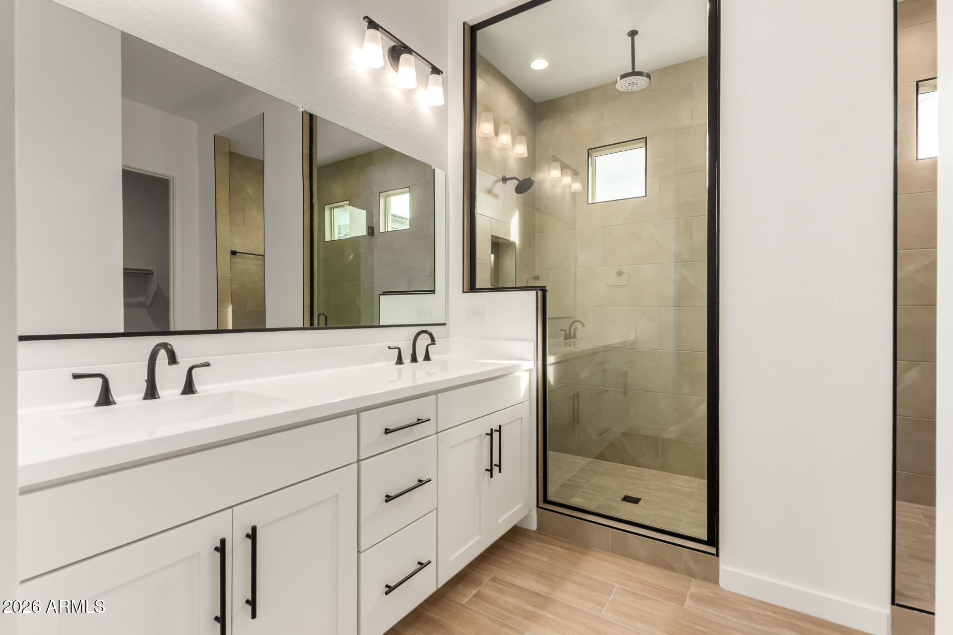 15890 West Miami Street Goodyear, AZ 85338 - Photo 14 of 51 a bathroom with a double vanity sink mirror and shower