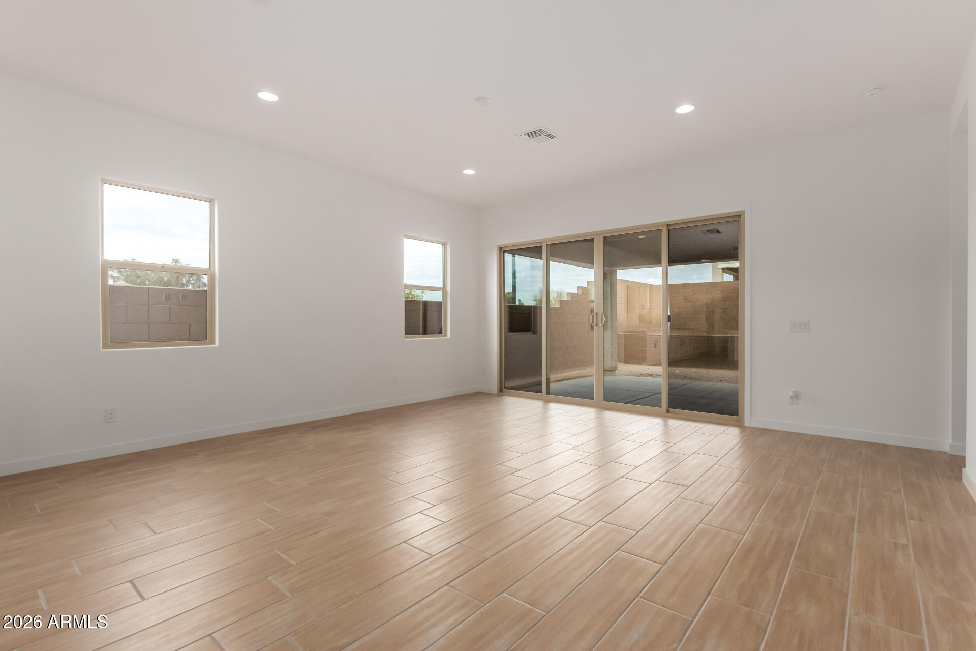 15890 West Miami Street Goodyear, AZ 85338 - Photo 6 of 51 an empty room with wooden floor and windows