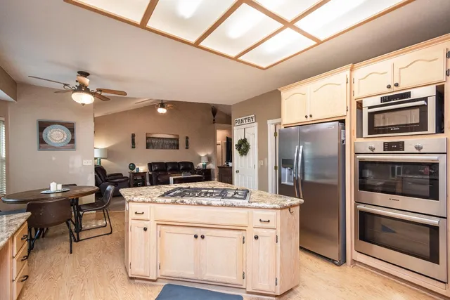 a kitchen with a stove a refrigerator and a microwave
