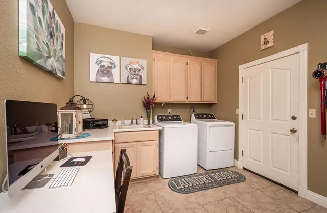 a kitchen with a refrigerator and a stove top oven