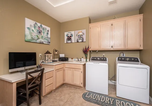 a view of a workspace with furniture and a flat screen tv
