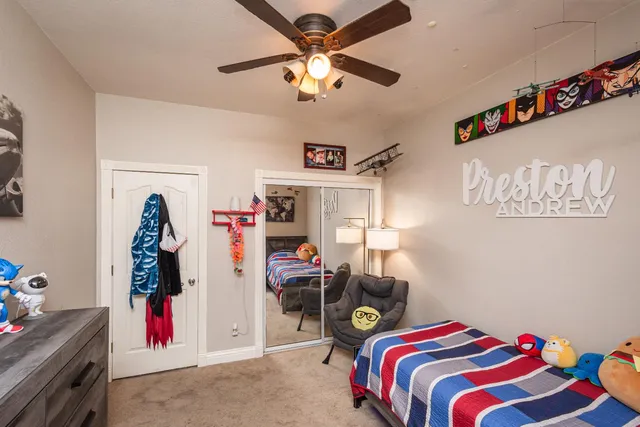 a bedroom with a bed a window and a lamp