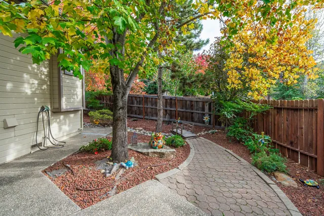 a view of a chair and table in backyard