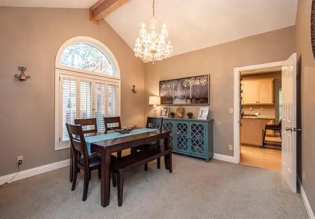 a dining room with furniture a chandelier and a rug