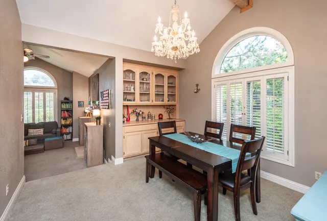 a dining room with furniture a rug and a chandelier