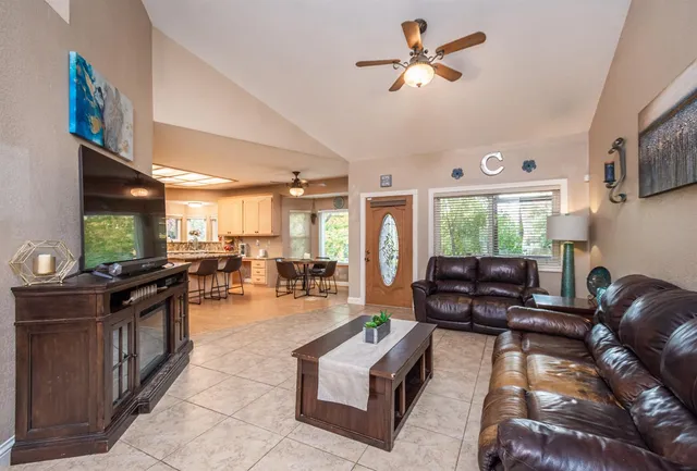 a living room with furniture a fireplace and a flat screen tv