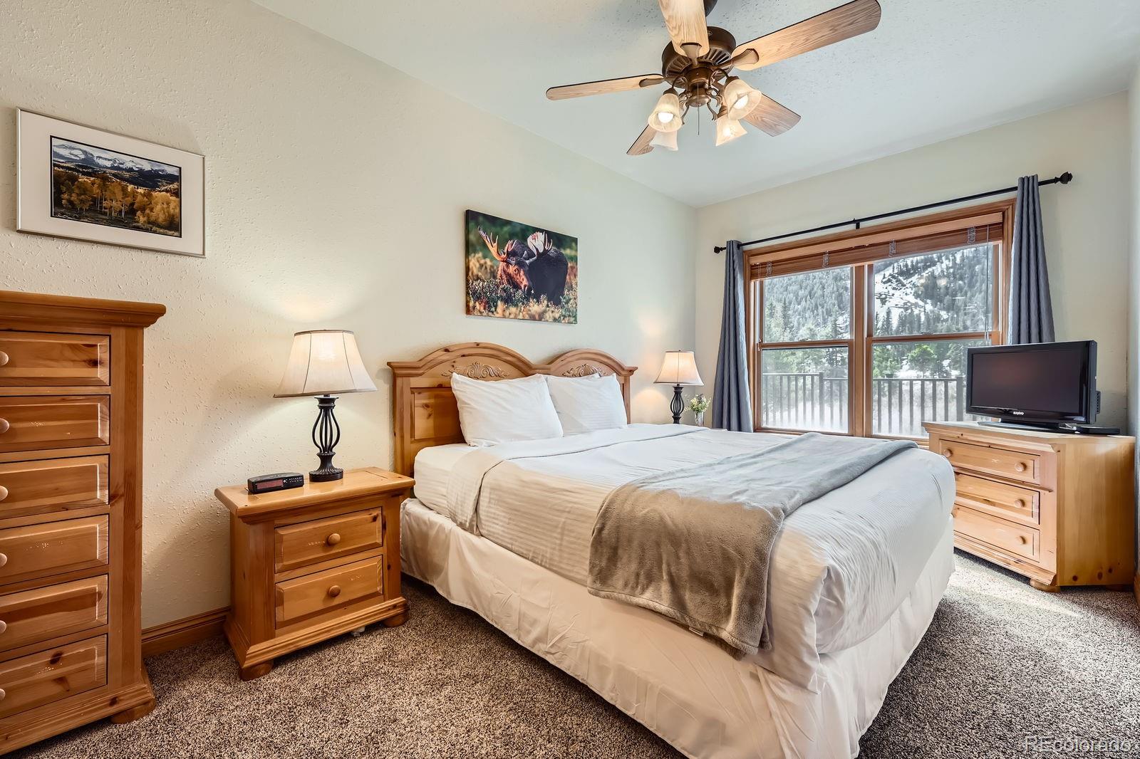 22714 Highway 6, Unit 5945 Keystone, CO 80435 - Photo 12 of 37 a bedroom with bed tv and window