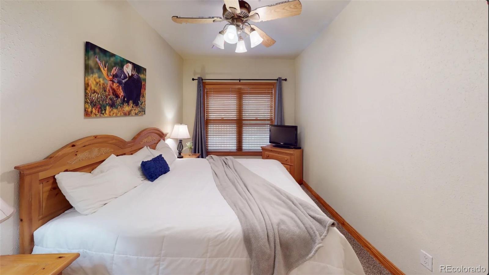 22714 Highway 6, Unit 5945 Keystone, CO 80435 - Photo 13 of 37 a bedroom with a bed and a chandelier