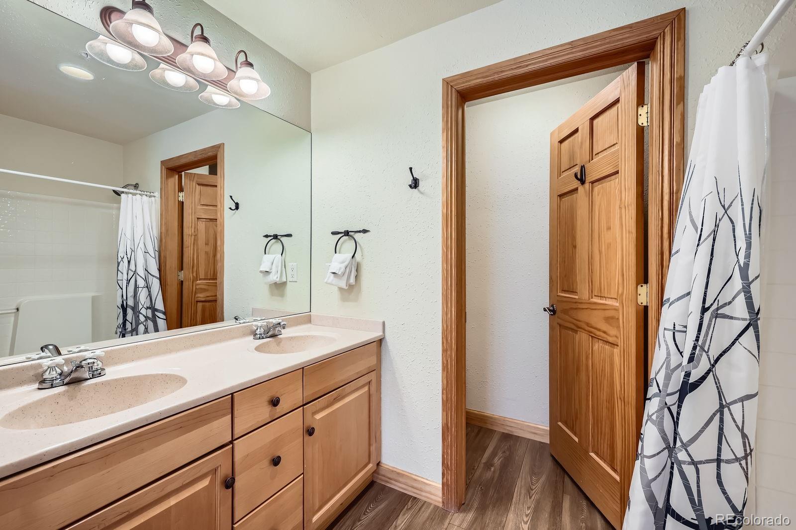 22714 Highway 6, Unit 5945 Keystone, CO 80435 - Photo 16 of 37 a bathroom with a double vanity sink mirror and shower