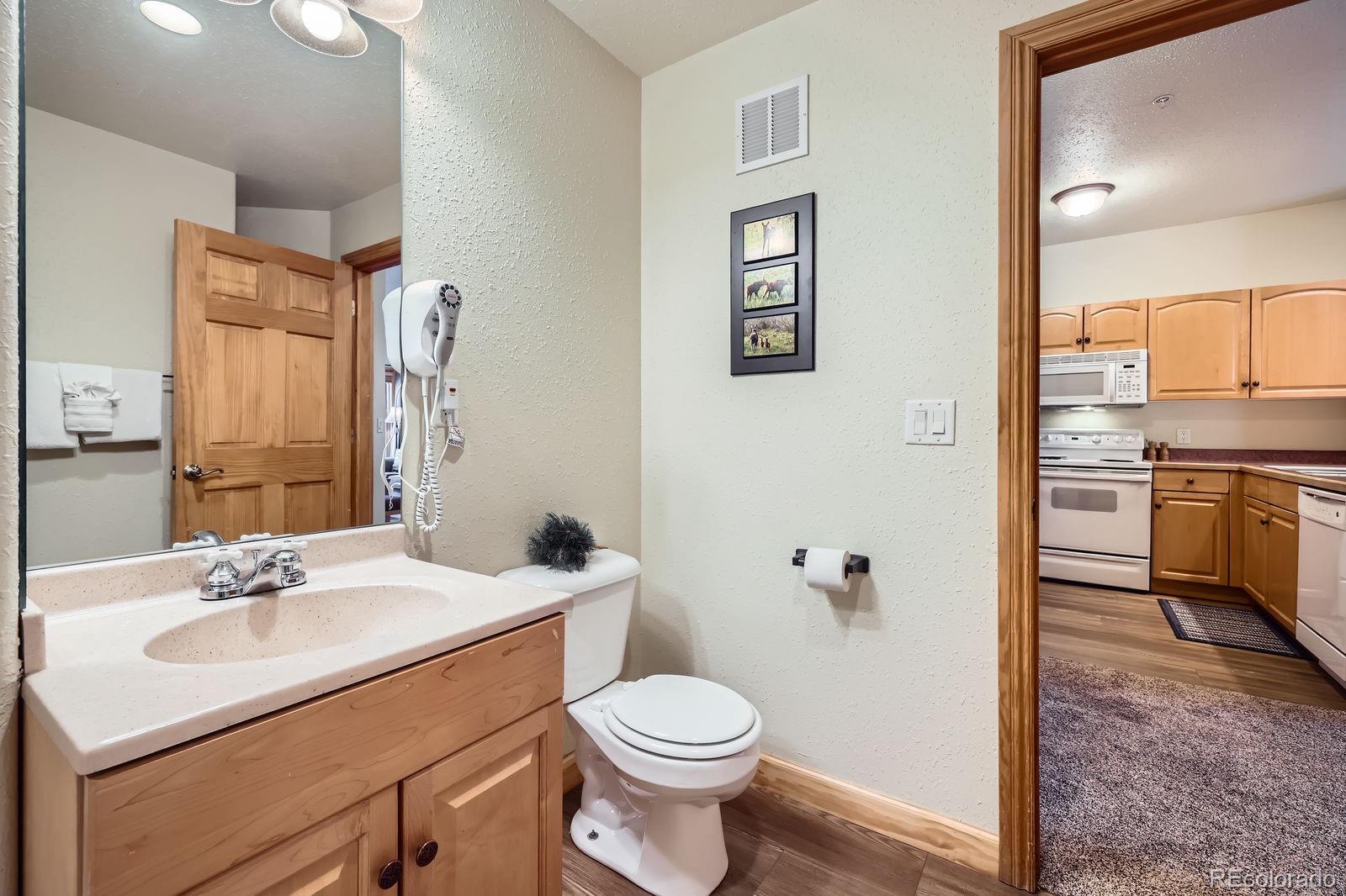 22714 Highway 6, Unit 5945 Keystone, CO 80435 - Photo 21 of 37 a bathroom with a sink toilet vanity and shower