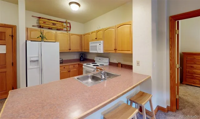 a kitchen with refrigerator cabinets and wooden floor