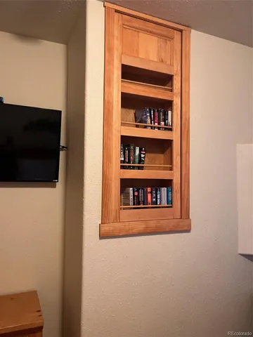 a view of a living room with a flat screen tv and a window