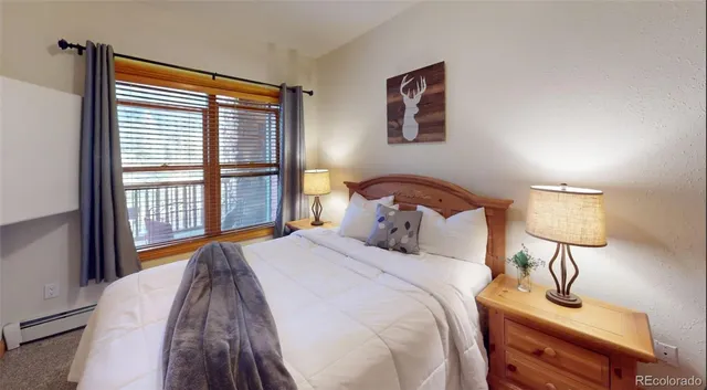 a bedroom with a bed and a lamp next to a window